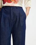 Model wears washed denim wide leg pants