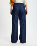 Model wears washed denim wide leg pants