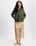 Gold lace skirt worn by a model on a white background