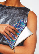 Model holds Fariba's Triangles Foldover Purse (Silver)