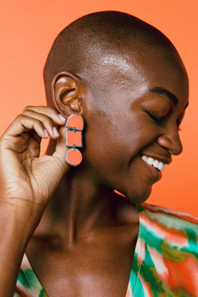 Model wears Quazi Design Orange Lindiwe Earrings