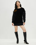 Model wears Starlings Velvet Pullover Dress