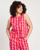 woman wears red and pink friendship beads screenprinted top with matching pants