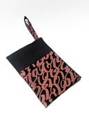 black clutch with strap against white backdrop