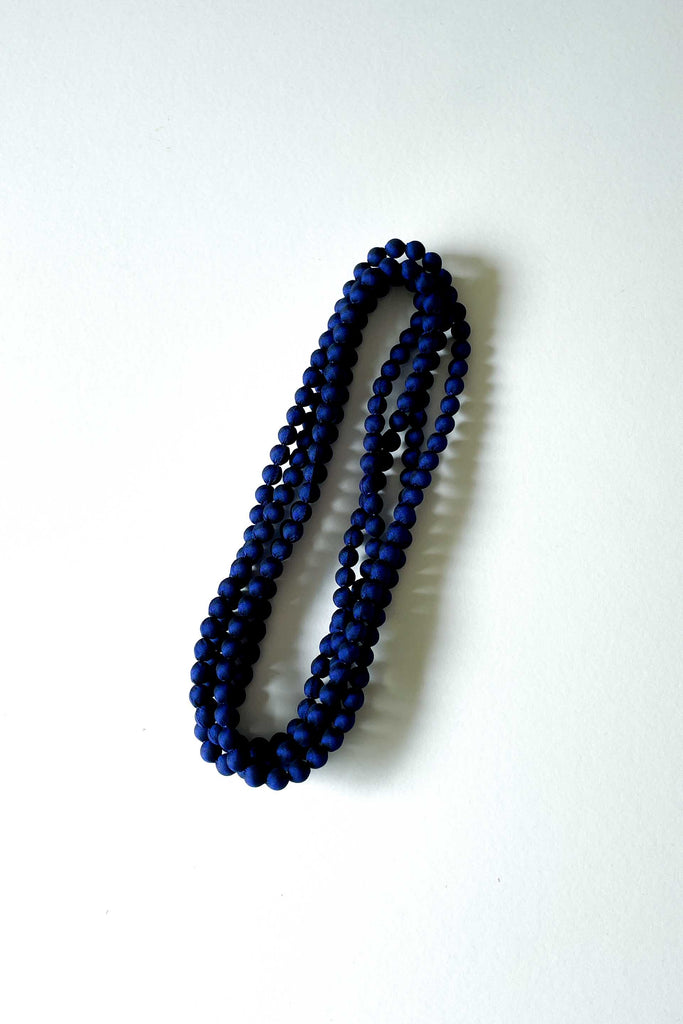 magical night dark blue silk long strand necklace by tabitha cambodia against white backdrop