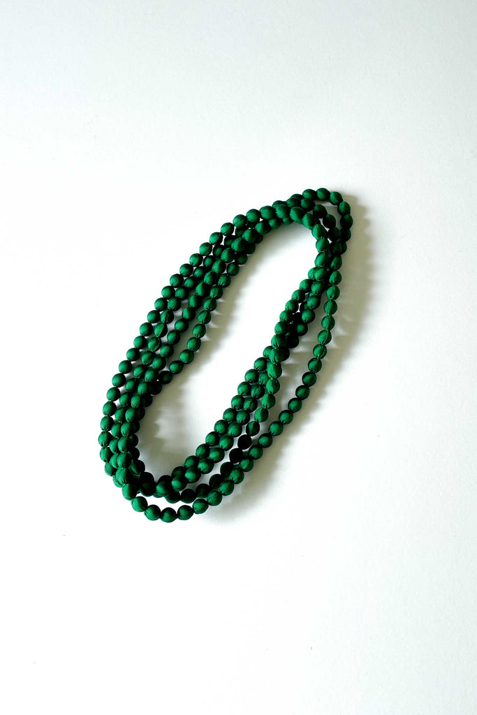 rainforest green silk long strand necklace by tabitha cambodia against white backdrop