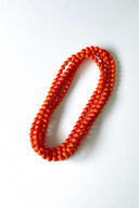 saffron orange silk long strand necklace by tabitha cambodia against white backdrop