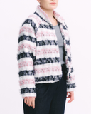 Person wearing a striped jacket with pink, white, and navy pattern on a white background