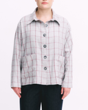 Person wearing a grey checkered shirt on a white background