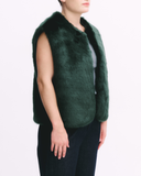 Green fur vest worn by a person on a white background