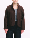 Brown jacket worn by a person on a white background