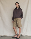 Model wearing a dark brown silk aviator bomber jacket.