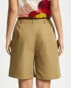 Model wears Bermuda Shorts in tan 