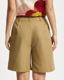 Model wears Bermuda Shorts in tan 