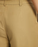 Model wears Bermuda Shorts in tan 