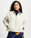 Model wears workwear jacket in a cream bone suede 