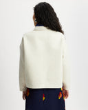 Model wears workwear jacket in a cream bone suede 