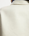 Model wears workwear jacket in a cream bone suede 