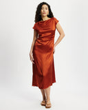 Woman wearing a rust-coloured satin midi dress 