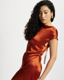 Woman wearing a rust-coloured satin midi dress 