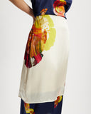 Model wears silk contrast midi skirt in Diya and Nour