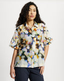 Model wears Relaxed shirt in a colourful watercolour semi sheer print.
