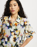 Model wears Relaxed shirt in a colourful watercolour semi sheer print.