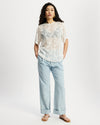 Model wearing white sheer oversized top.