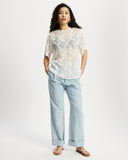 Model wearing white sheer oversized top.