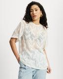 Model wearing white sheer oversized top.