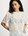 Model wearing white sheer oversized top.