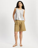 Model wears sleeveless Scoop shell top in sunbeam silver