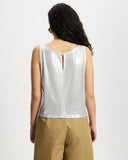 Model wears sleeveless Scoop shell top in sunbeam silver with keyhole button closure
