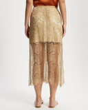 Gold lace skirt worn by a model on a white background