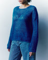 Person wearing a blue sweater against a white background