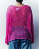 Person wearing a pink sweater and blue jeans against a white background