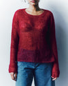 person wearing a red mohair knitted jumper