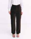Brown pants worn by a person on a white background
