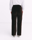 Brown pants worn by a person on a white background