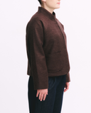 Brown jacket worn by a person on a white background