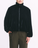 Black velvet jacket worn by a person on a white background