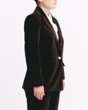 Brown velvet blazer worn by a person on a white background