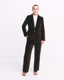 Person wearing a brown suit on a white background