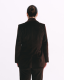 Person wearing a brown suit on a white background