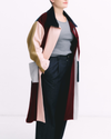 Person wearing a colorful coat with a white background