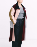 Person wearing a colorful coat with a white background