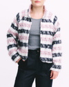 White, pink and navy jacket worn by a woman against a white background.