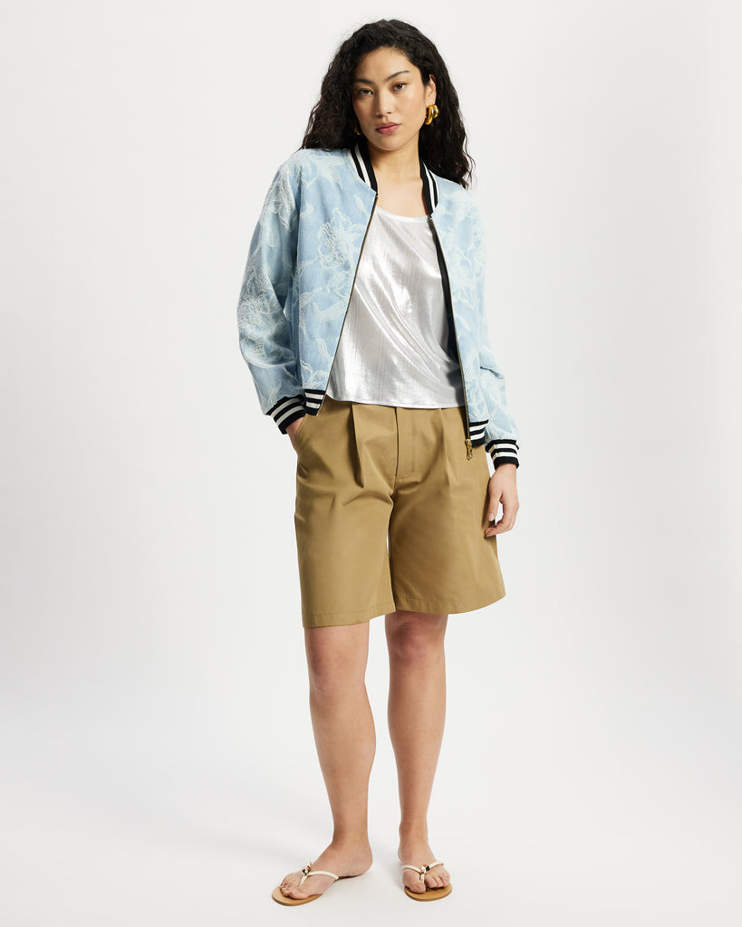 Model wears aviator in light denim with white floral large scale pattern.