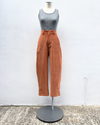 Mannequin wearing a gray top and brown pants against a white background