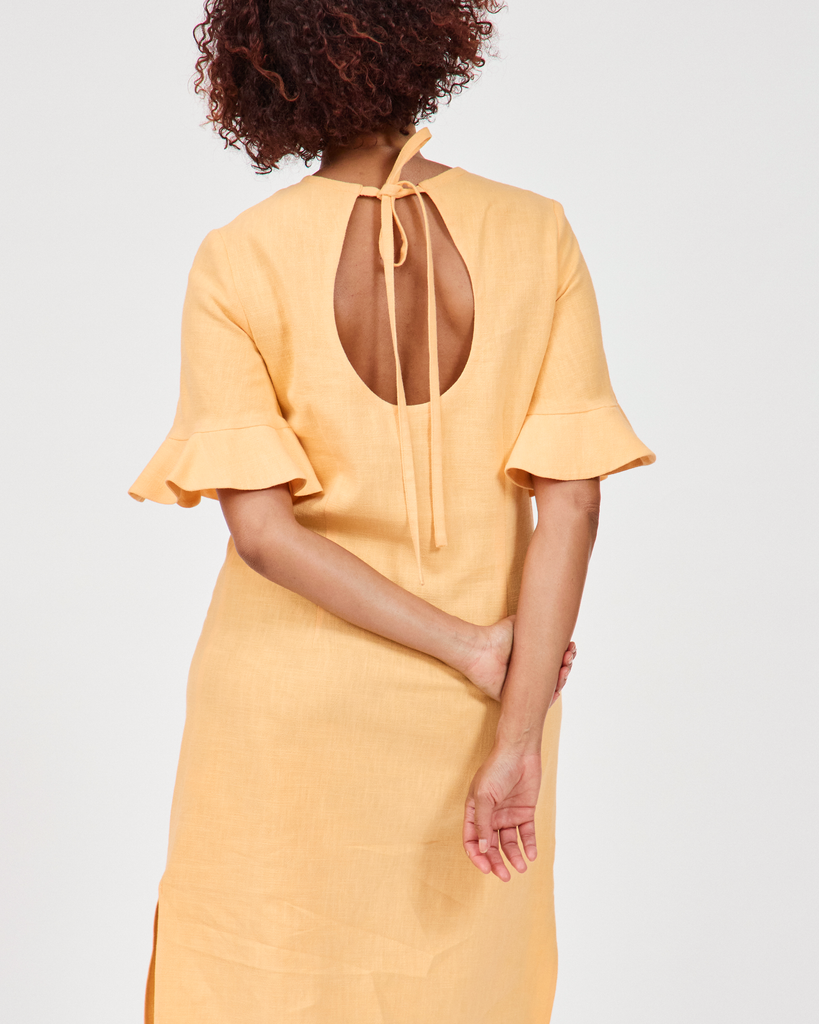 Model wears Billy Linen Dress in butterscotch